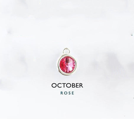 Jewelry charm with pink gemstone and 'October Rose' text on a white background