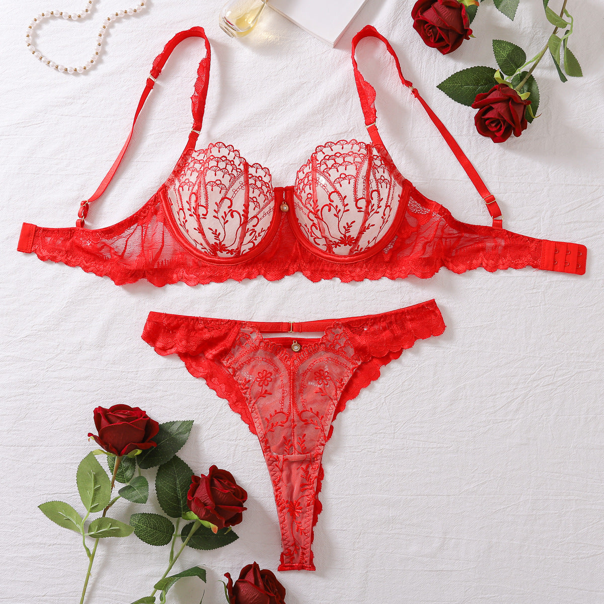 Red lace lingerie set with roses on a white background