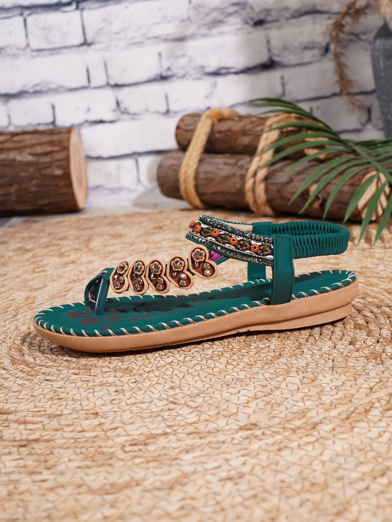 Green sandal with decorative straps on a woven surface with a rustic background