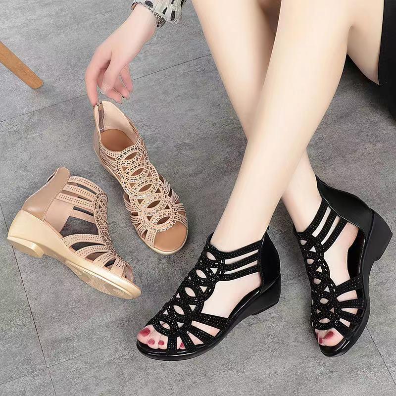 Black and beige sandals on a gray floor