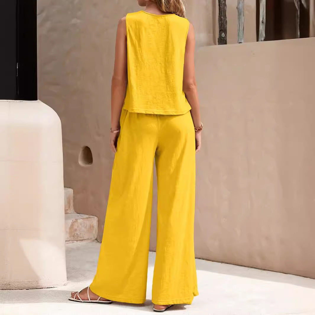 Person wearing a yellow outfit standing in an outdoor setting with a neutral background