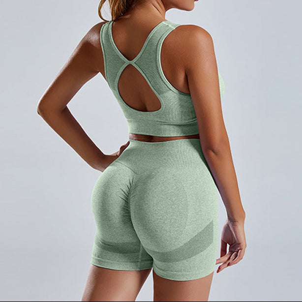 Woman wearing a green athletic outfit on a gray background