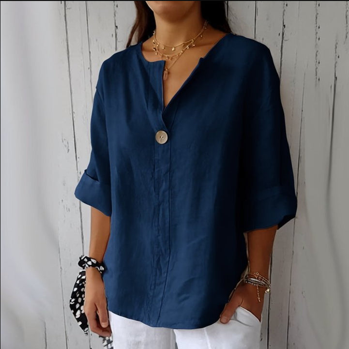 Person wearing a blue shirt with a neutral background