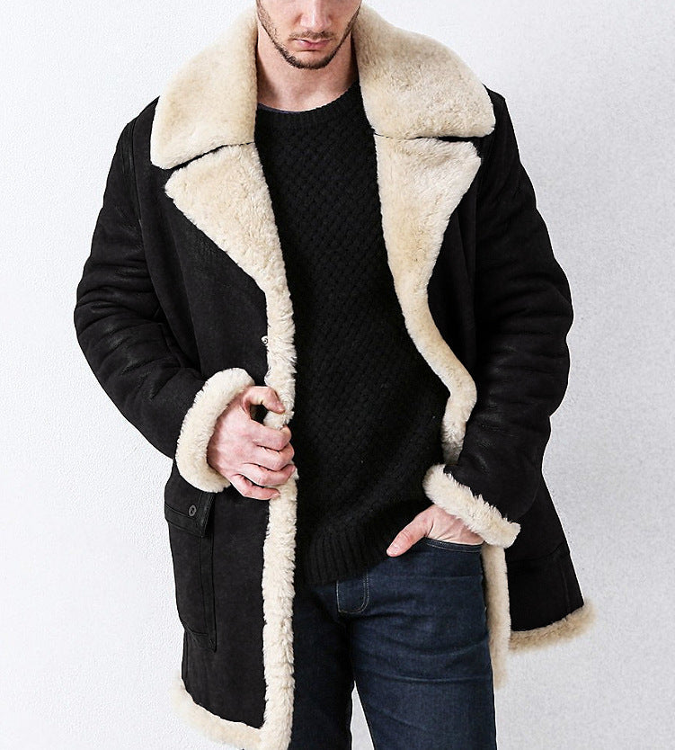 Man wearing a black coat with beige shearling collar against a white background