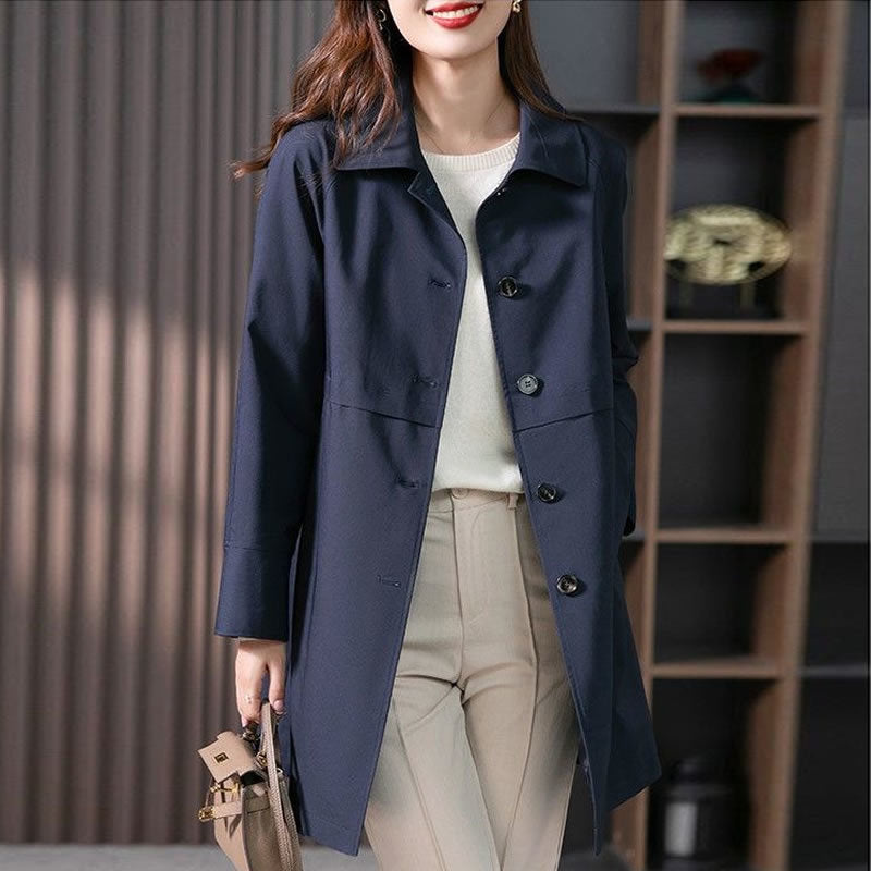 Woman wearing a navy blue coat in an indoor setting