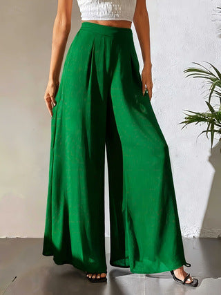 Person wearing green wide-leg pants against a neutral background