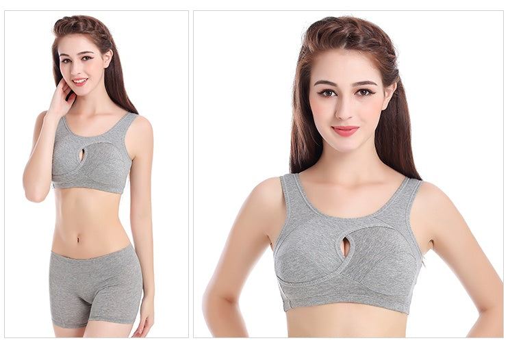 Woman wearing a gray sports bra and shorts set on a white background