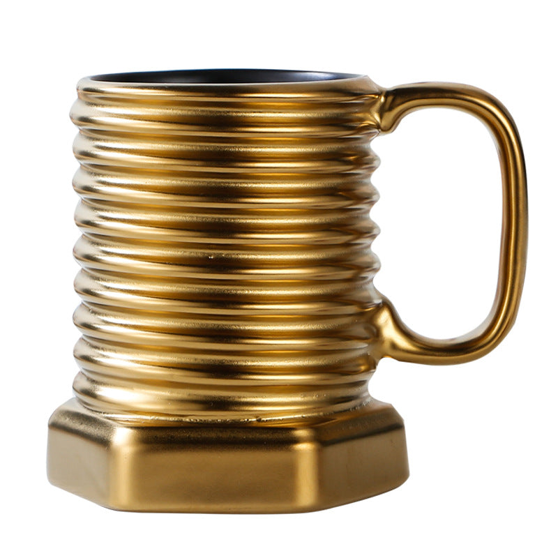 Gold mug with ribbed design on a white background