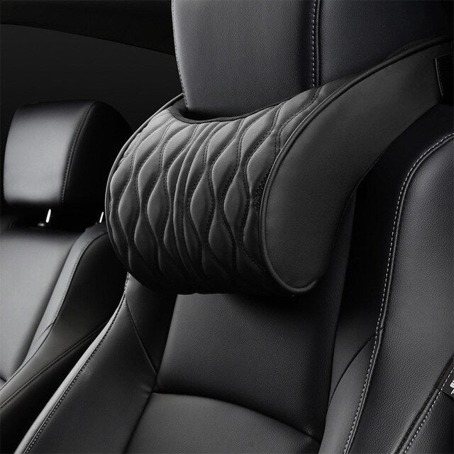 Car interior with a quilted headrest cover on a black leather seat