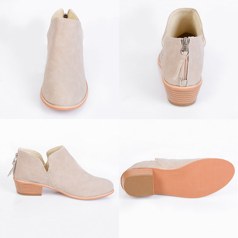 Beige ankle boots with brown soles on a white background