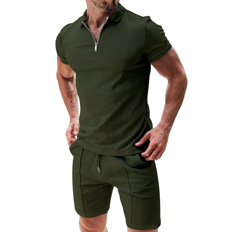 Man wearing a green short-sleeve shirt and shorts set on a white background