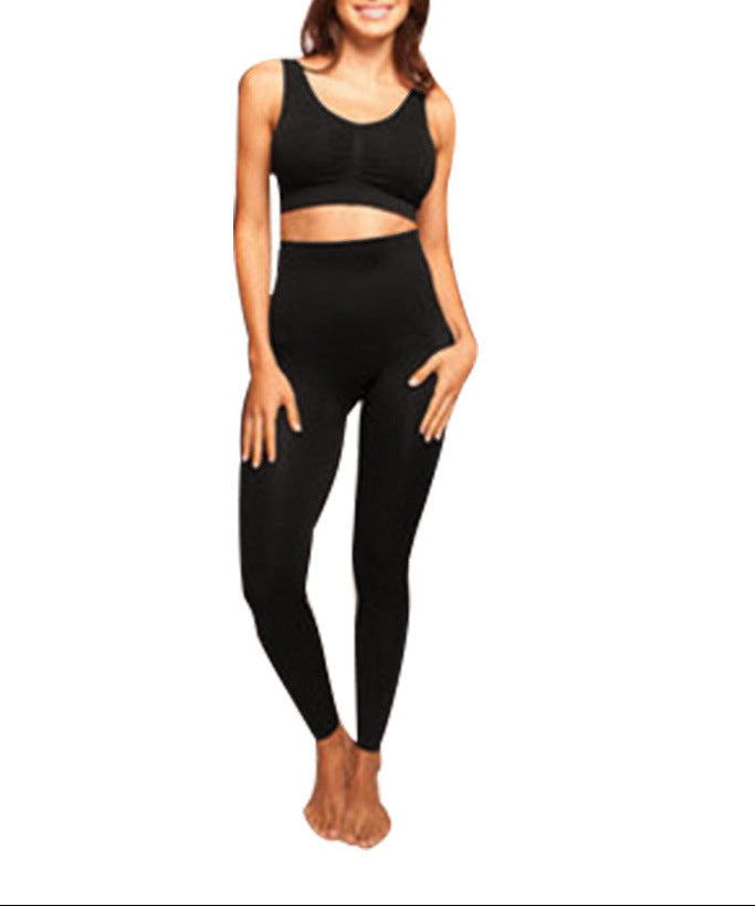 Woman wearing a black athletic outfit on a white background