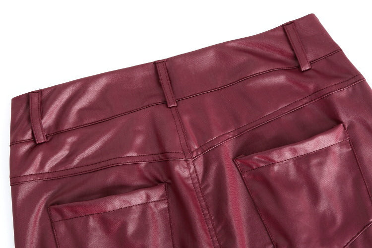 Close-up of maroon leather pants on a white background