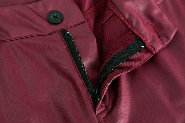 Close-up of a maroon jacket with a zipper and button detail.