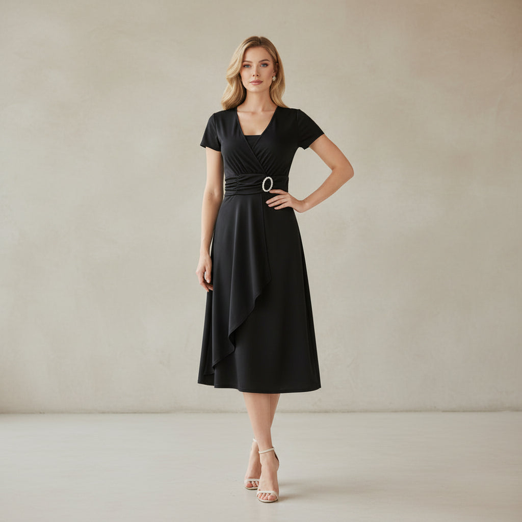 Woman wearing a black dress with a belt on a white background