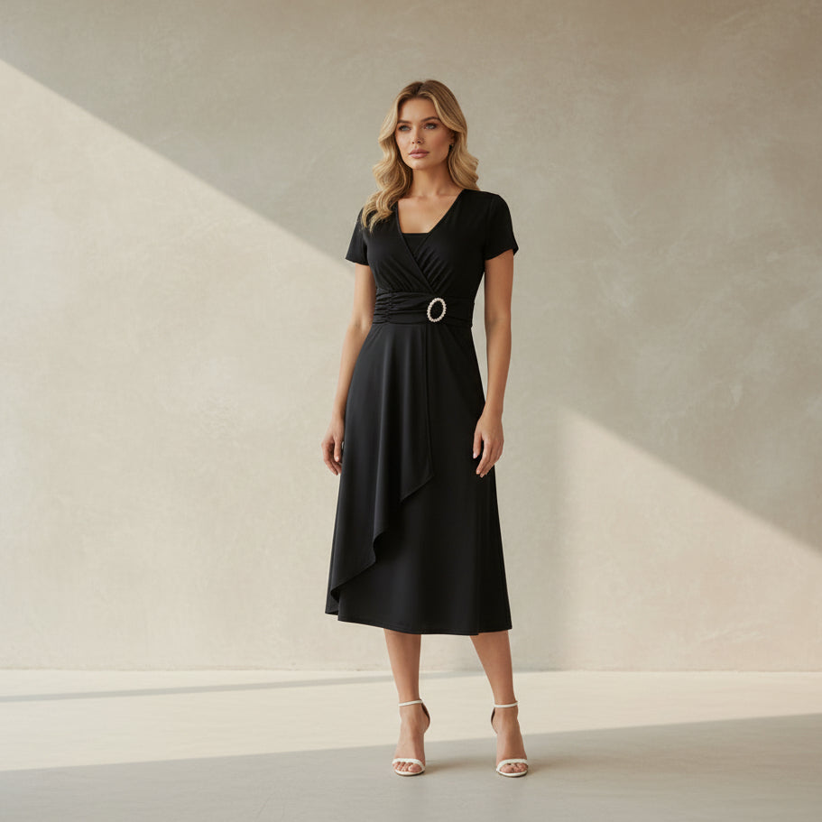 Woman wearing a black dress with a belt on a white background