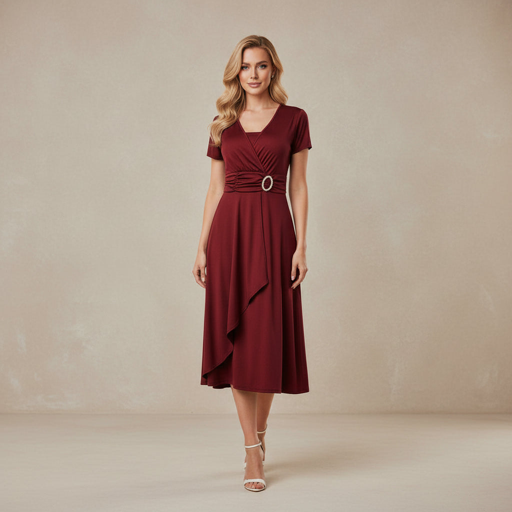 Red dress with a belt worn by a model on a white background