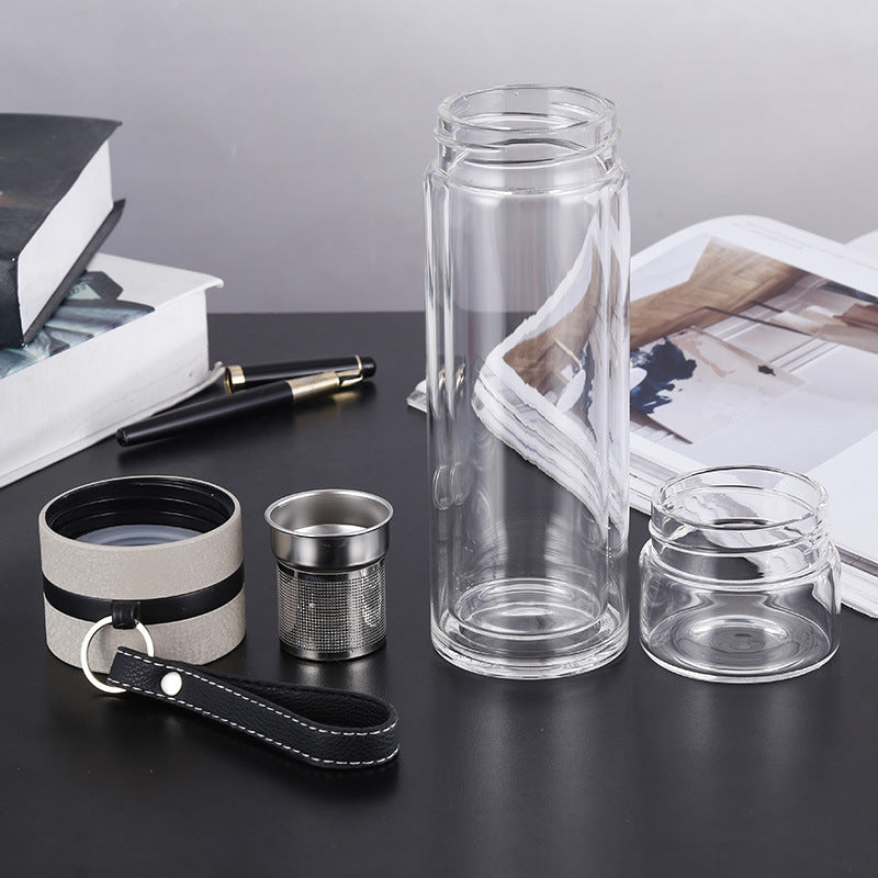 Clear glass bottle with accessories on a dark surface