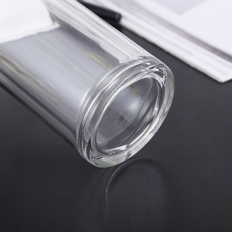 Clear glass container on a dark surface with a white background