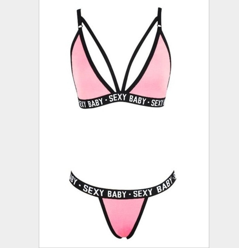 Pink bikini top with black straps and 'SEXY BABY' text on a white background