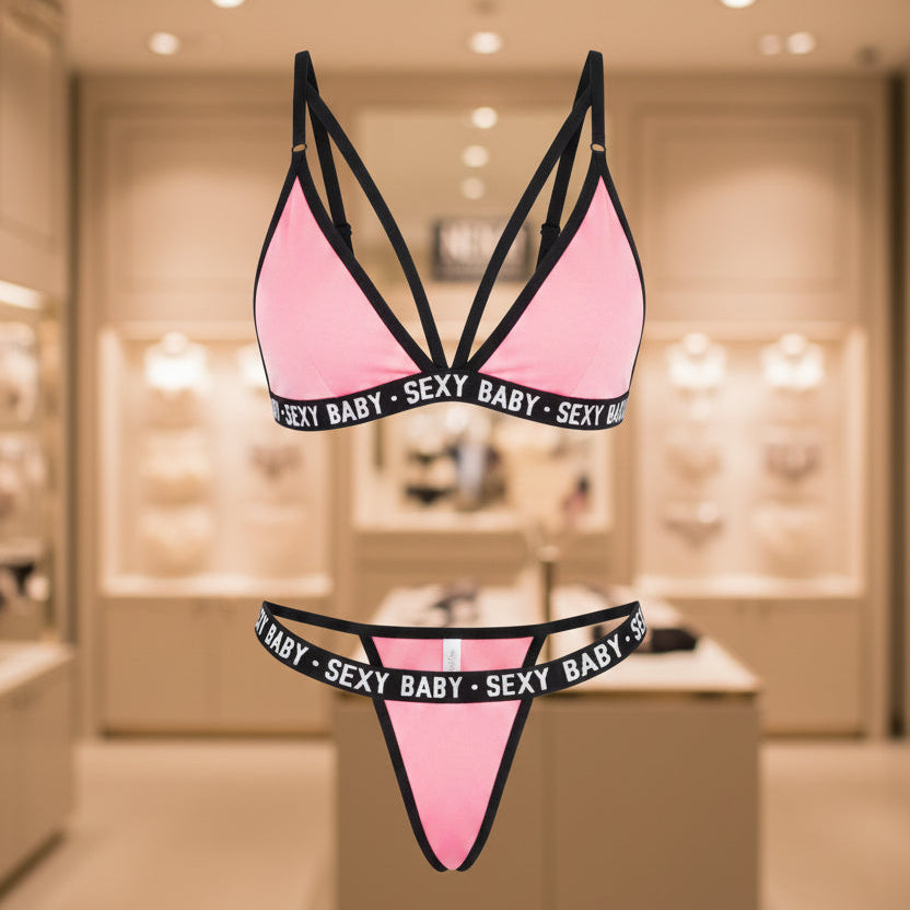 Pink bikini top with black straps and 'SEXY BABY' text on a white background