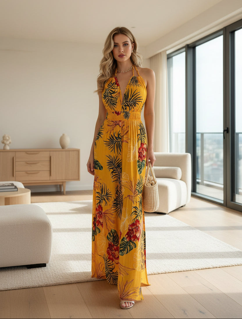 Woman wearing a yellow floral dress against a plain background
