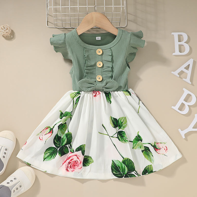 Green top and floral skirt set on a beige background with 'BABY' letters.