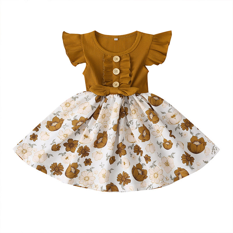 Children's dress with mustard yellow top and floral skirt on a white background