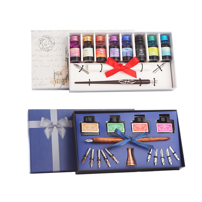 Calligraphy set with ink bottles, nibs, and tools in a decorative box on a white background