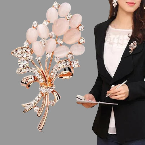Woman wearing a brooch resembling a bouquet of pink flowers with a white background
