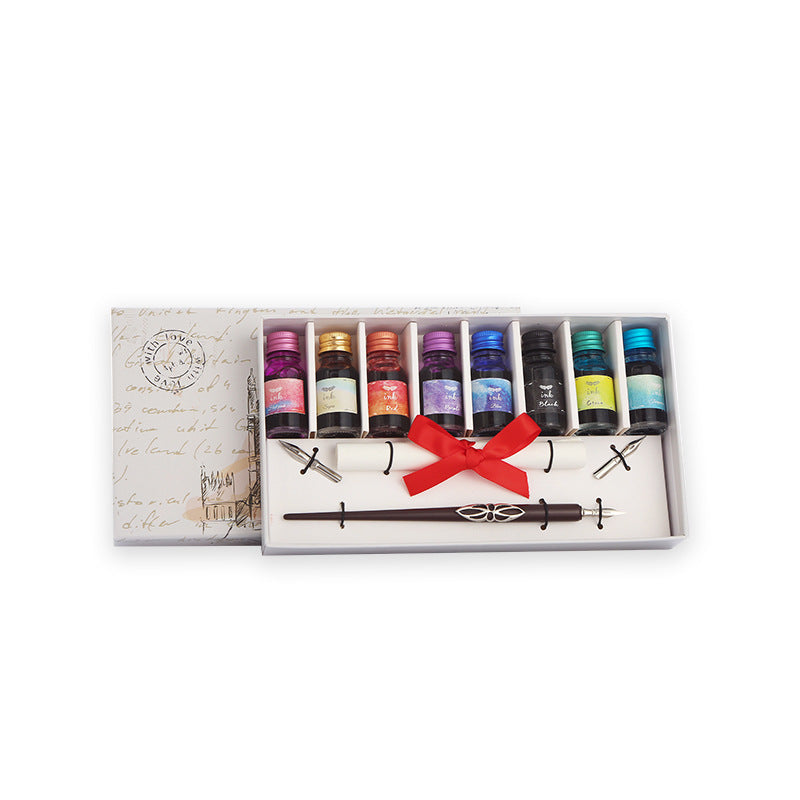 Set of colorful ink bottles with a red ribbon in a gift box on a white background