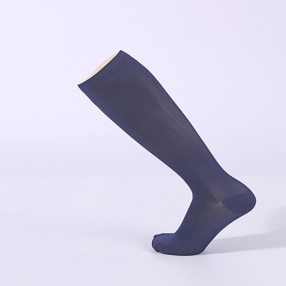 Navy blue knee-high sock on a light purple background