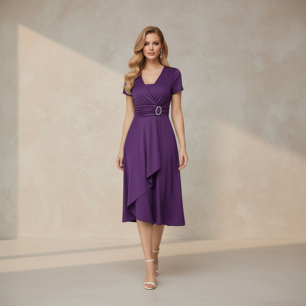 Woman wearing a purple dress with a belt on a white background