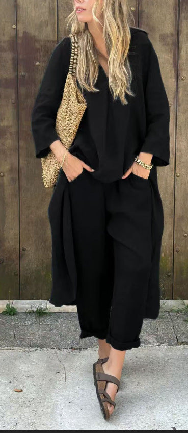 Person wearing a black outfit with a textured bag against a wooden background