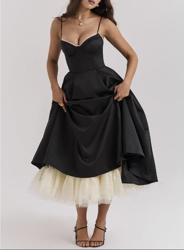 Black evening gown with a white tulle skirt on a plain background