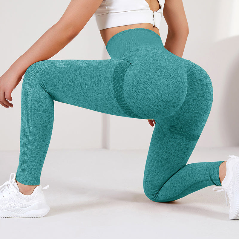 Teal leggings worn by a person on a light background