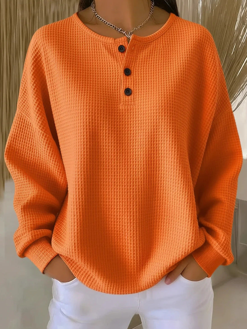 Orange textured long-sleeve shirt worn by a person with a neutral background