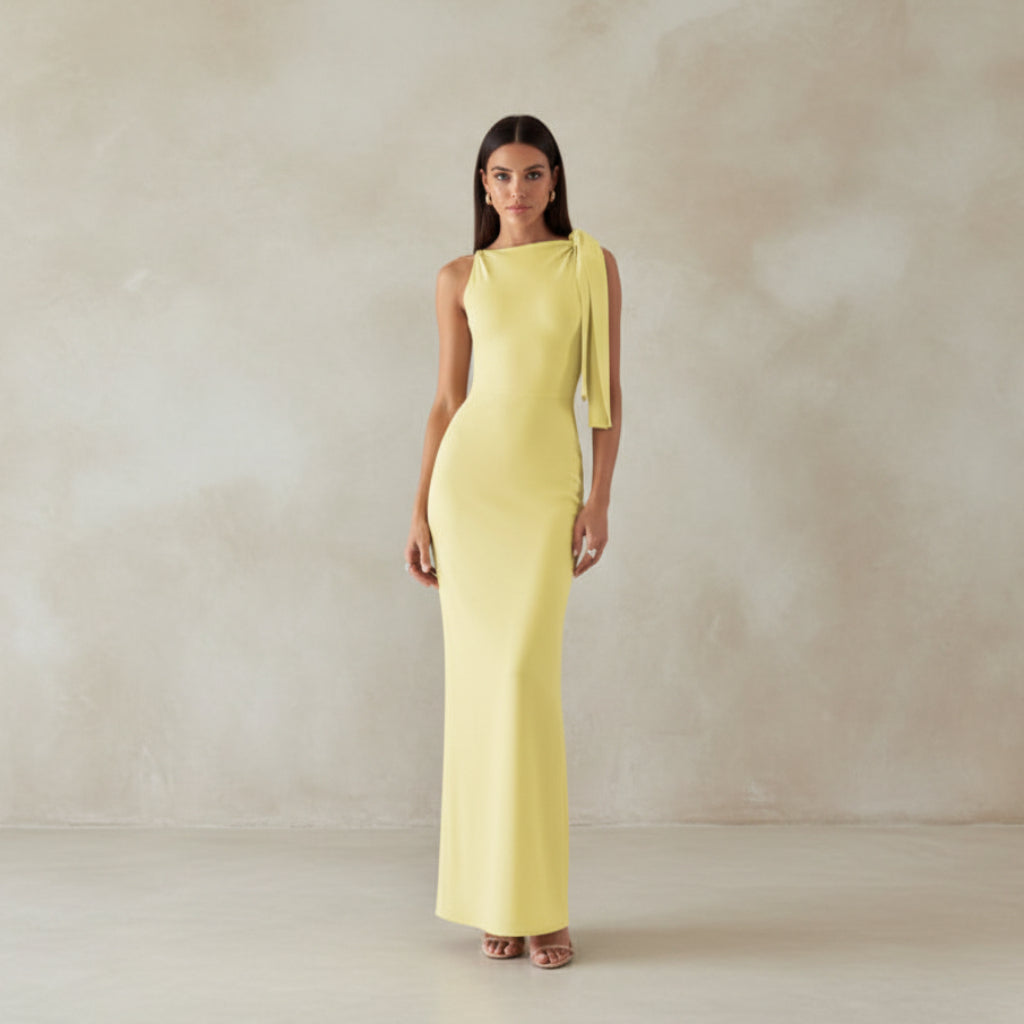 Woman in a yellow dress standing on a staircase