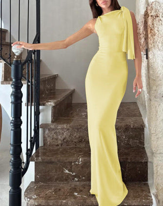 Woman in a yellow dress standing on a staircase