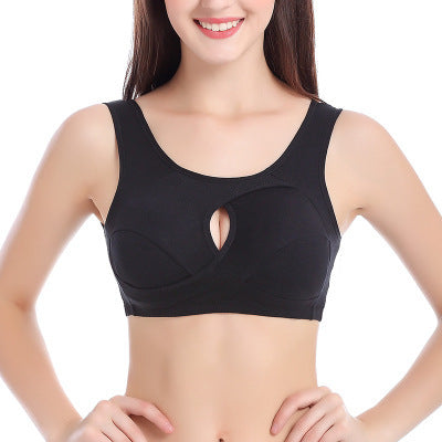 Woman wearing a black sports bra on a white background