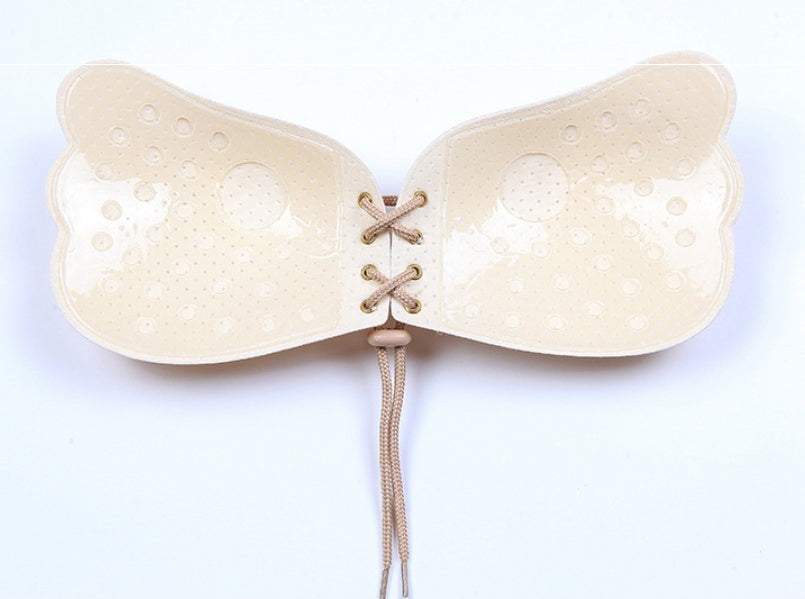Beige silicone bra on a white background