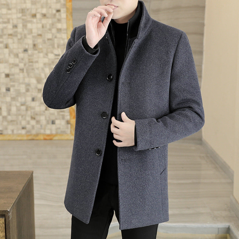 Person wearing a gray coat in an indoor setting