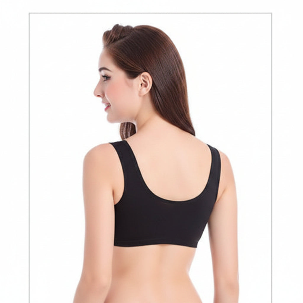 Woman wearing a black sports bra and shorts set on a white background