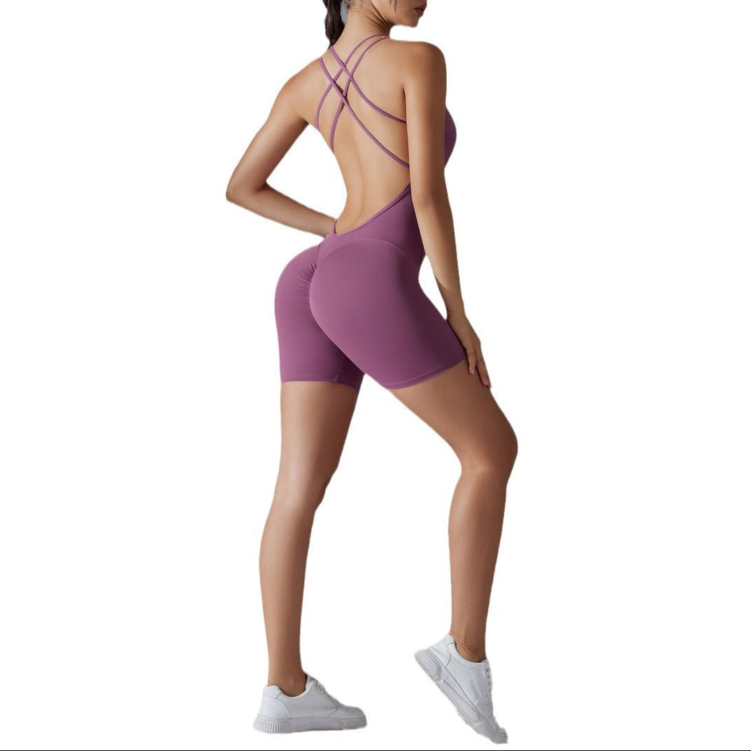 Woman wearing a purple athletic outfit with a backless design on a white background