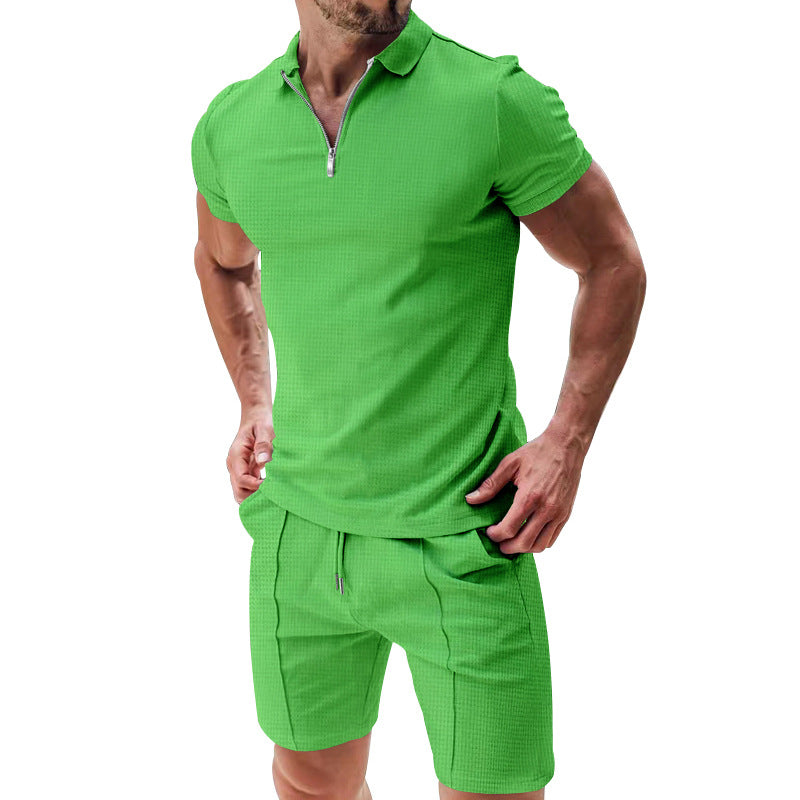 Green polo shirt and shorts set on a white background
