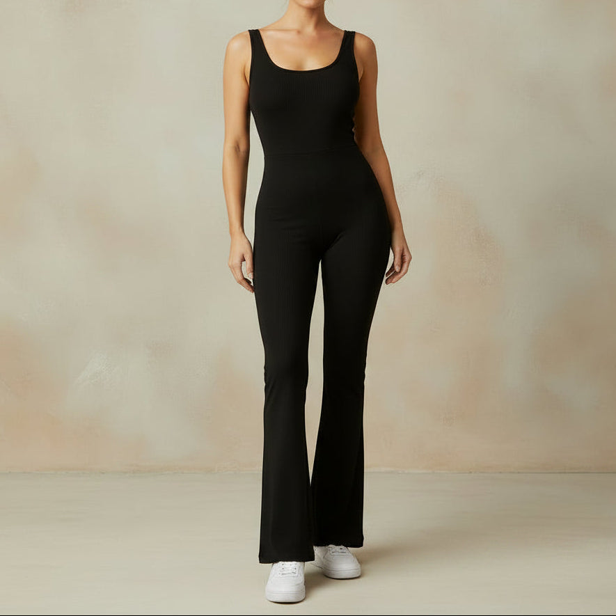 Person wearing a black jumpsuit by a waterfront