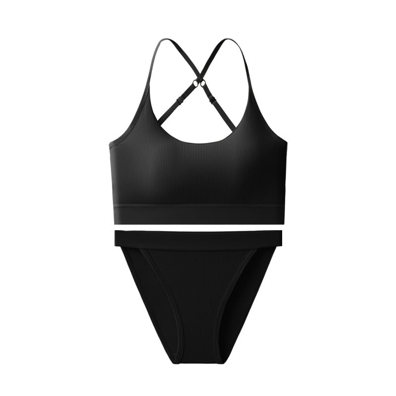 Black swimsuit with criss-cross straps on a white background