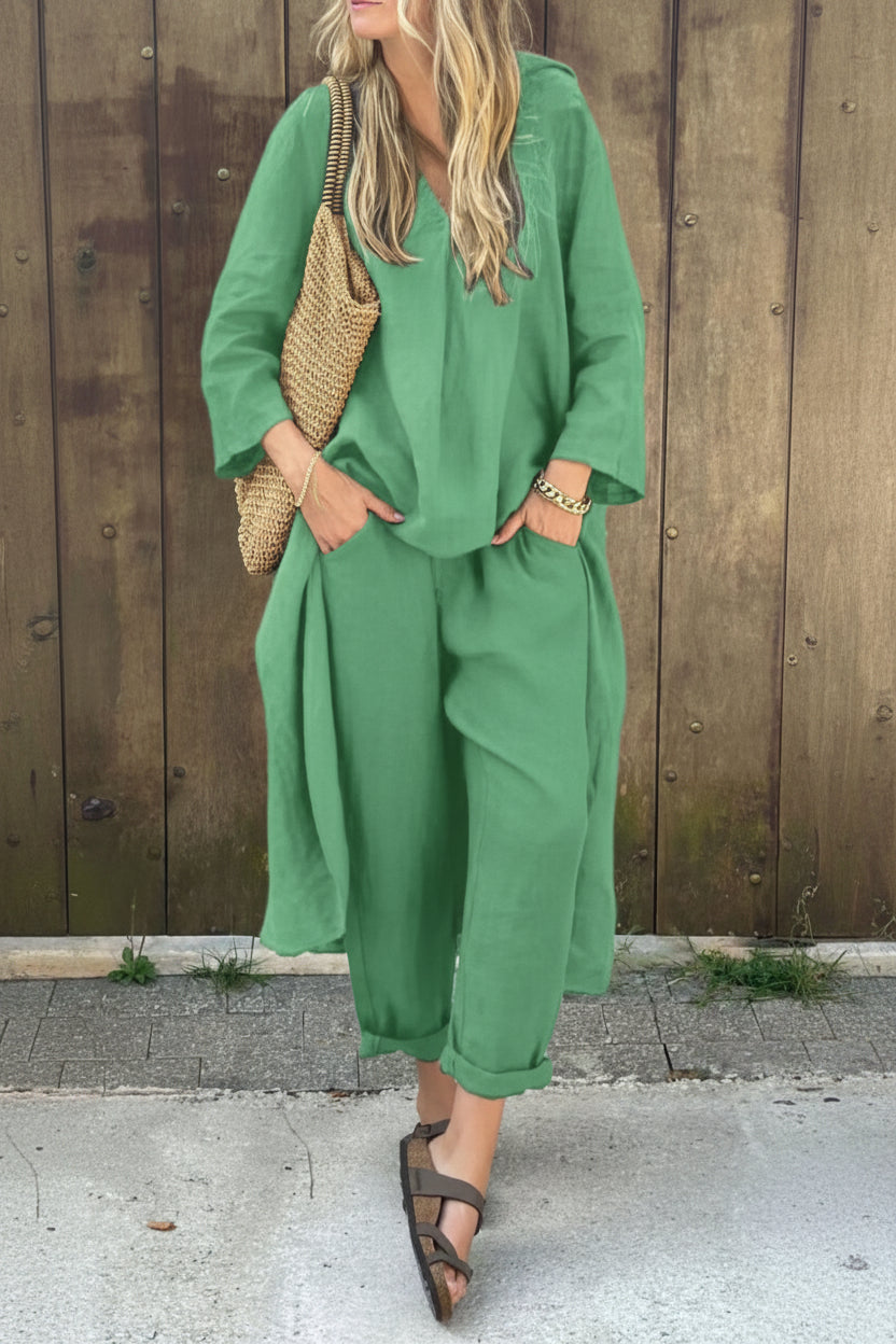 Person wearing a green outfit with a wooden background