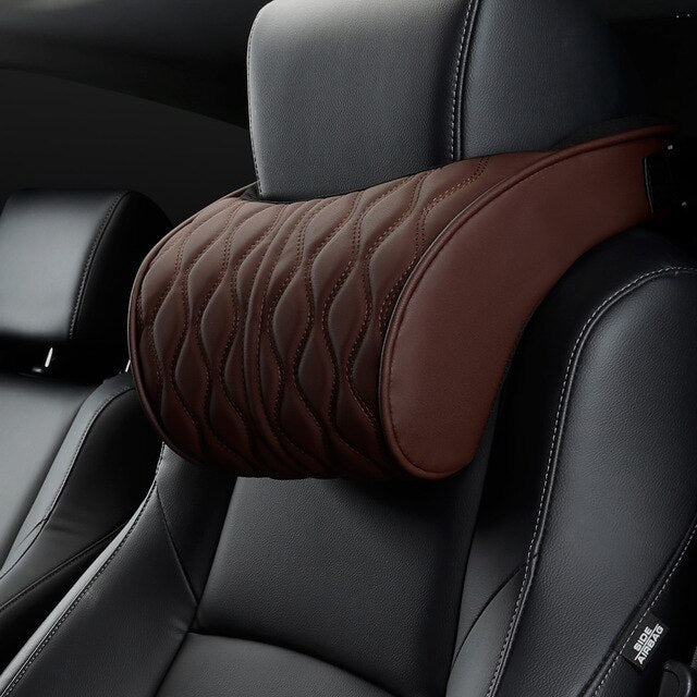 Brown quilted headrest pillow on a car seat