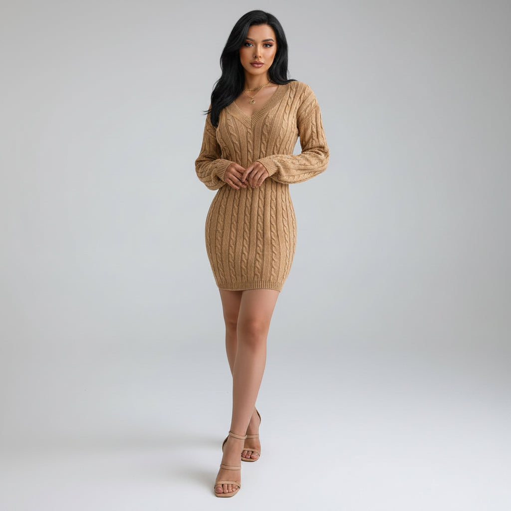 Beige cable knit sweater dress worn by a person indoors.